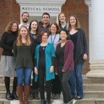 Criss Lab members standing on steps of the Old UVA Med School Building