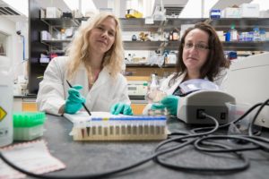 Researchers Melissa Kendall, left, and Beth Melson in lab