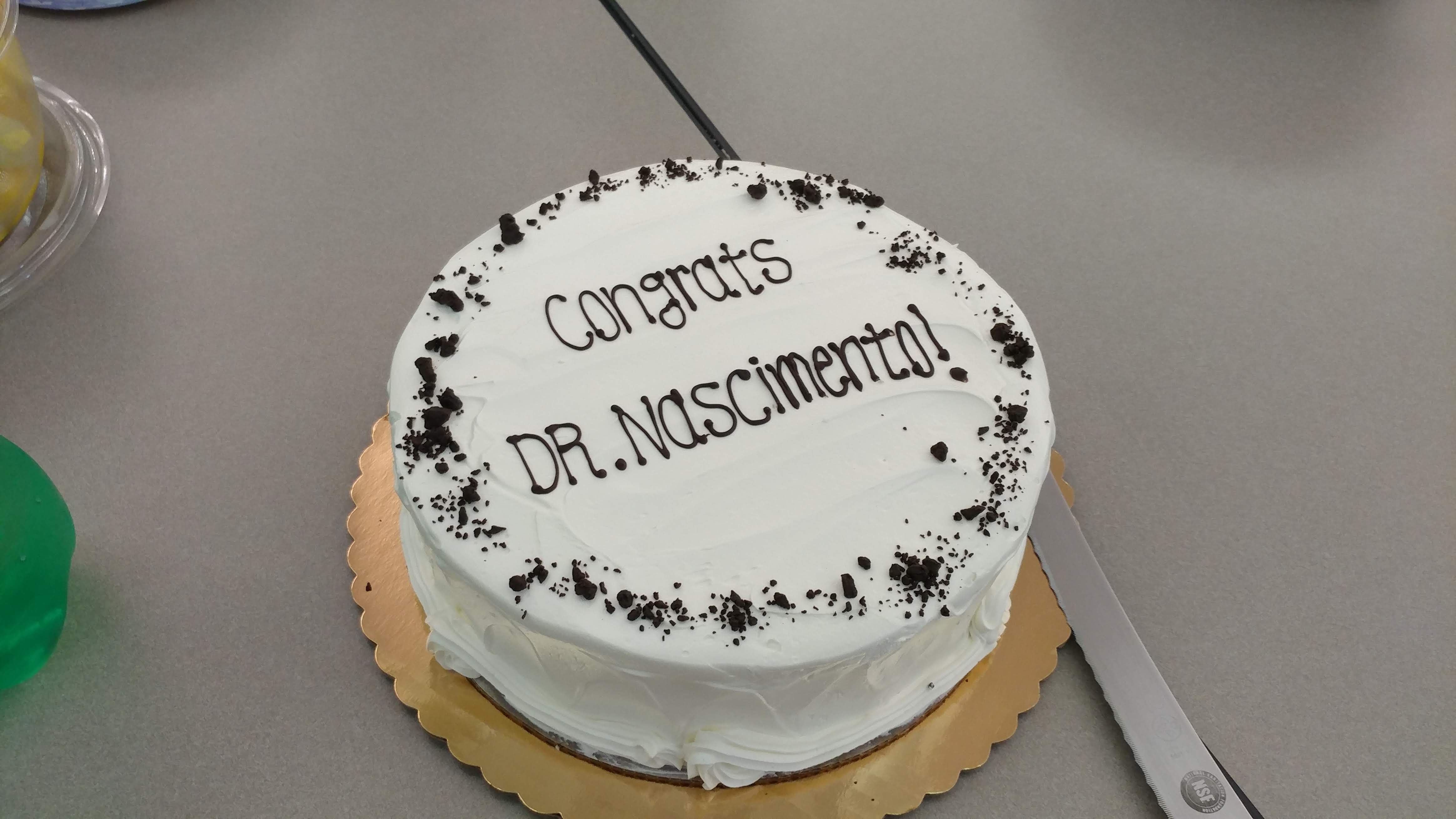 White cake to celebrate Dr. Nacimento's defense. 