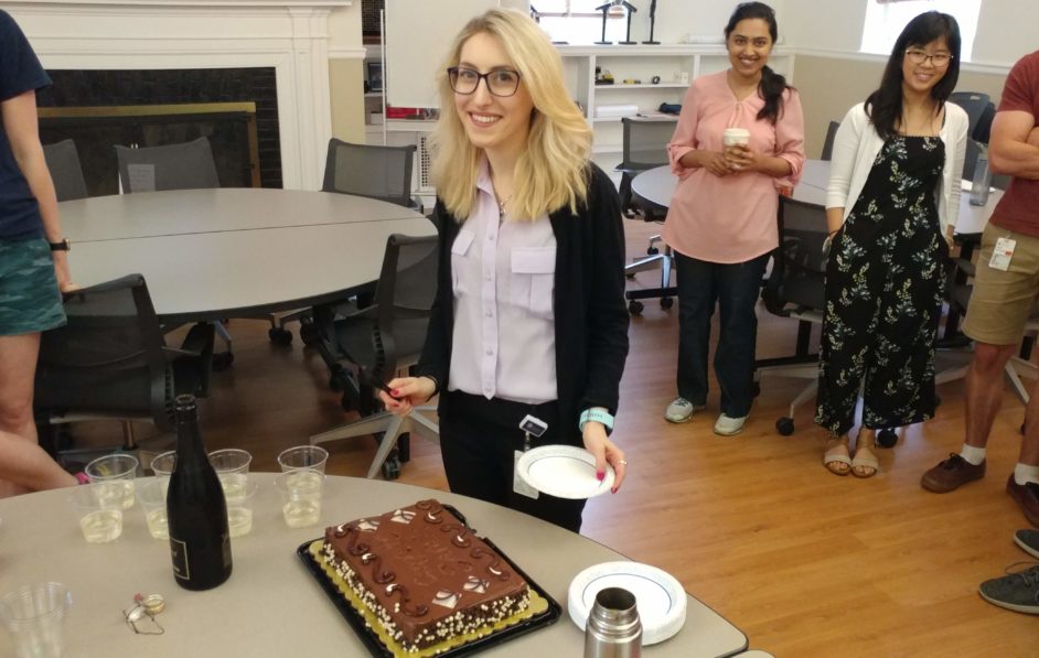 Sarah cutting her cake to celebrate her defense